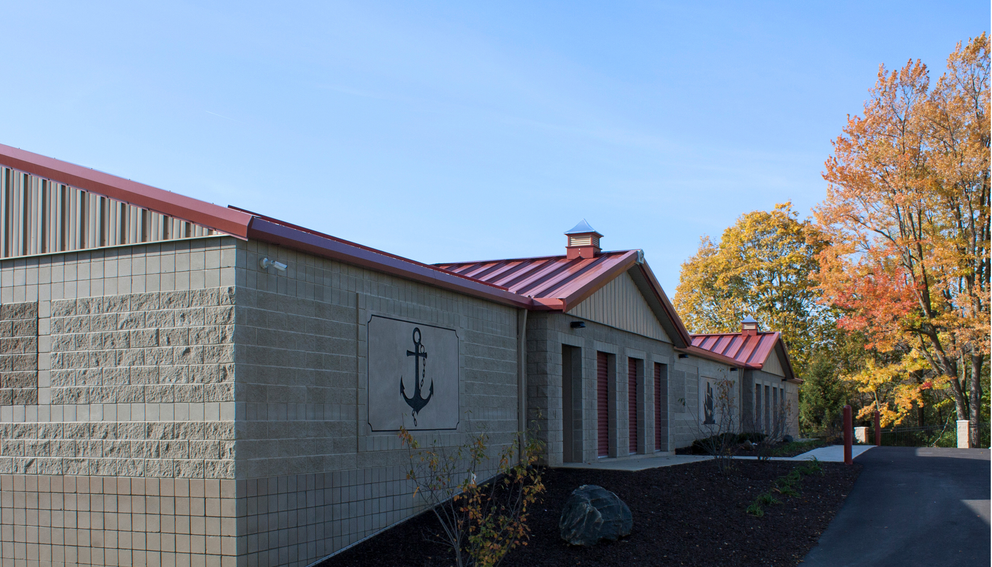 Exterior view of a self-storage development featuring coordinated multi-building design, durable steel construction and a cohesive operational environment developed to support efficient tenant access and long-term property performance.
