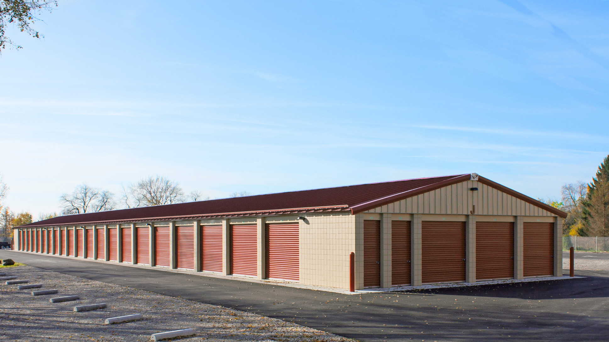 Exterior view of the Vanston/O'Brien, Inc. self-storage facility featuring coordinated multi-building design, durable steel construction and consistent operational layout developed to support efficient tenant access and long-term property performance.