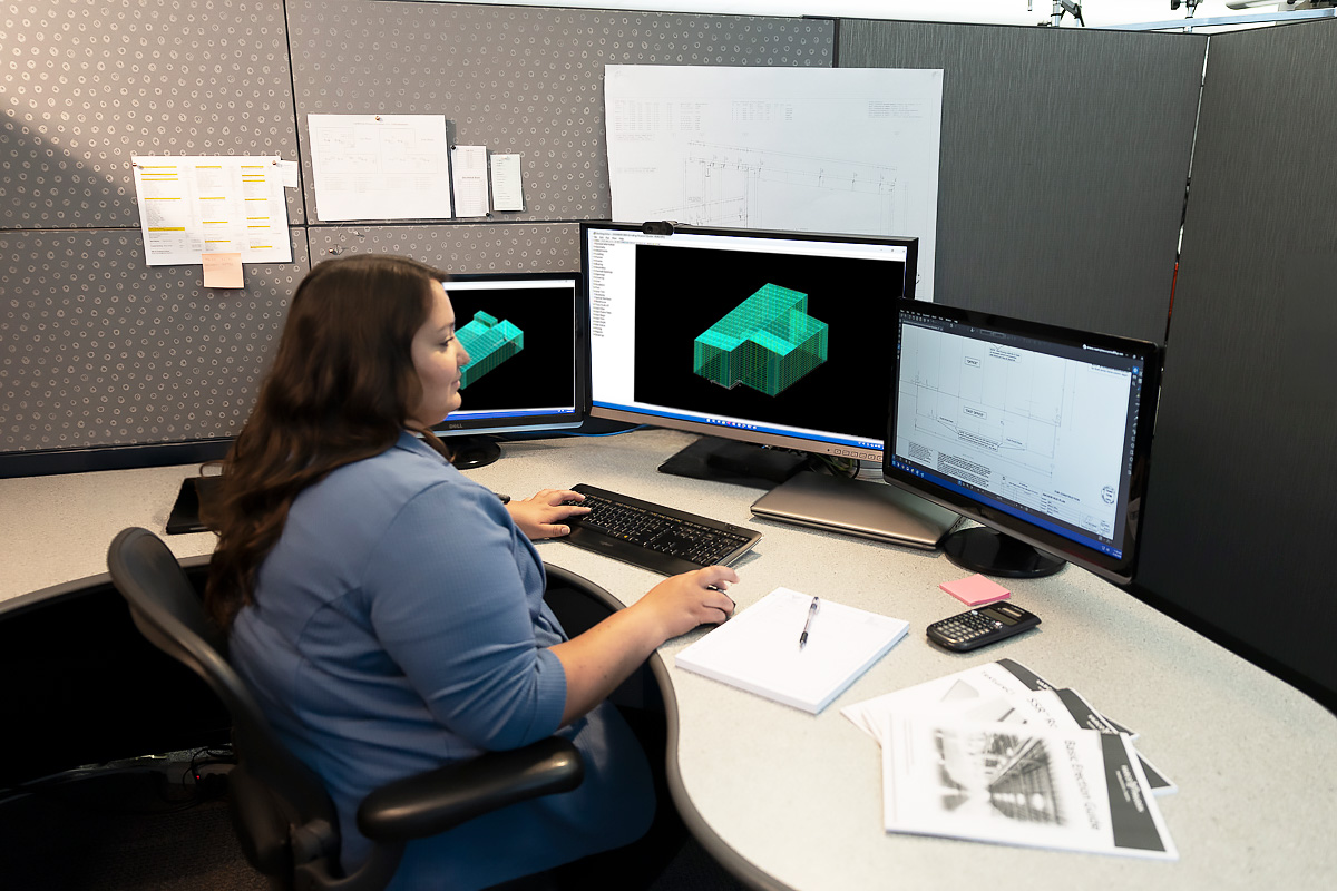 Woman seated at desk using VP Command Software