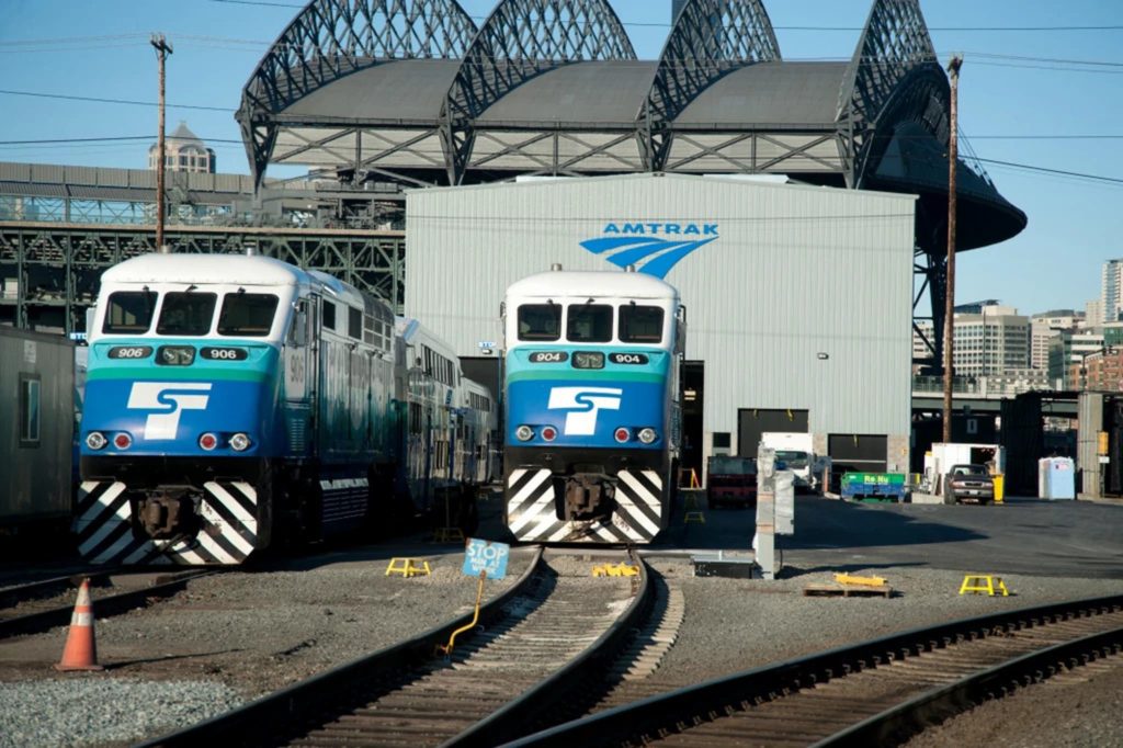 Amtrak Pacific Northwest Maintenance Facility exterior with logo and two train car systems