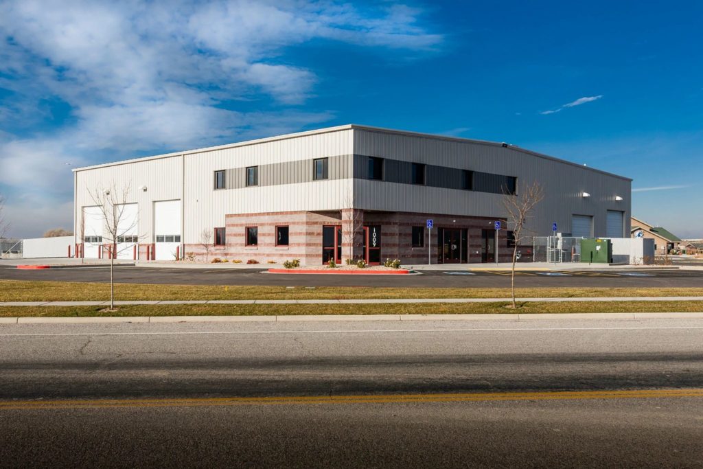 Lewis Bus Group building exterior with pavement and blue skies